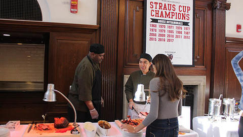 student getting food and speaking with dining staff