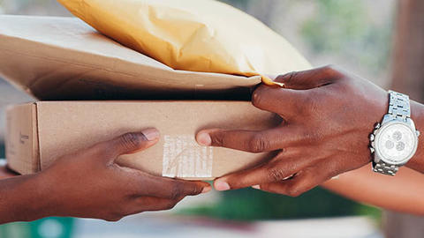person handing mail to another