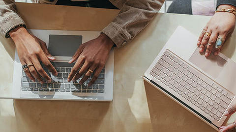people typing on laptops
