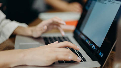 person typing on laptop