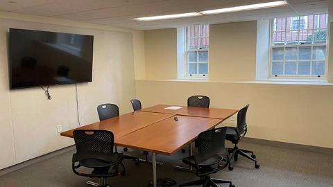 Photo of S009 with conference table and mounted TV