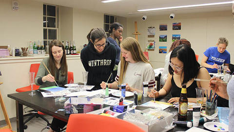 students painting in an art room