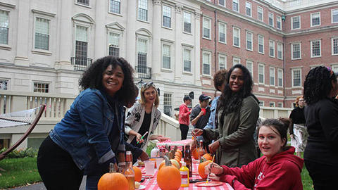 students painting pumpkins