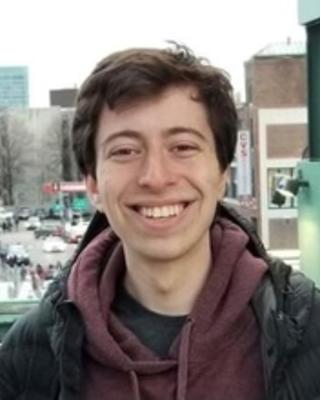 headshot of Resident Tutor Zack in a winter coat at Fenway Park