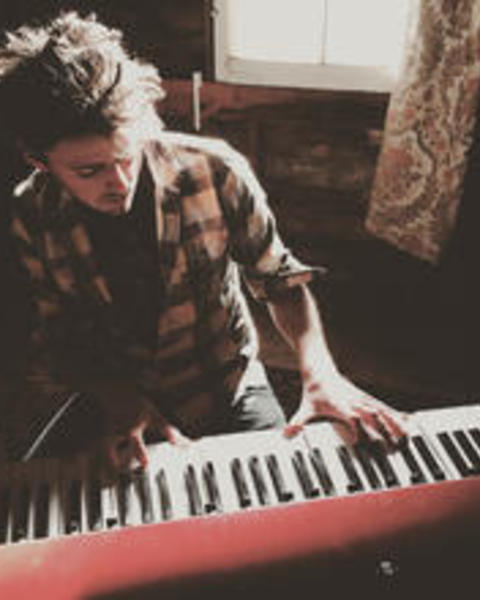 photo of Non-Resident Tutor, Ben playing the piani