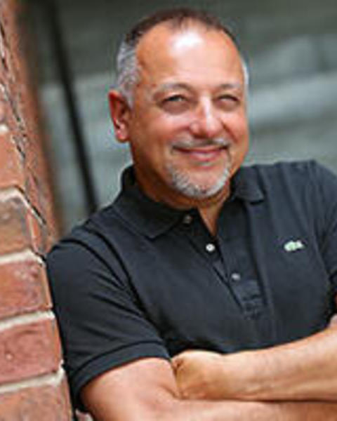 photo of Non-Resident Tutor, Jeff leaning against a red brick wall