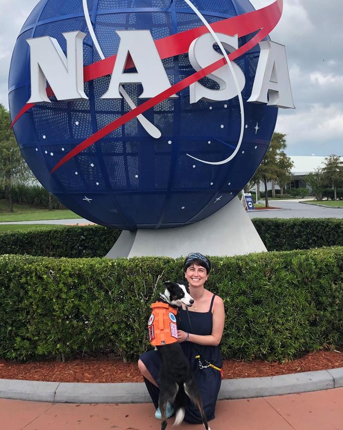 Tutor, Ciara sitting in front of the NASA logo statue